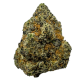 A close-up image of a cannabis flower with a brownish tint, featuring a dense, compact structure with trichomes visible on the surface.